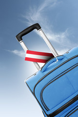 Destination Austria. Blue suitcase with flag.