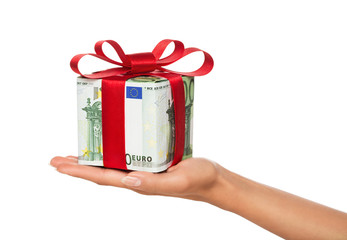 Female hand holding gift made of euro banknotes isol