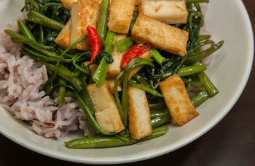 Stir-fried Morning Glory with tofu fish on rice.