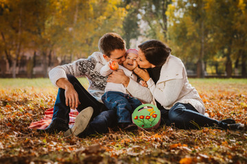 Happy mother, father and daughter in the park