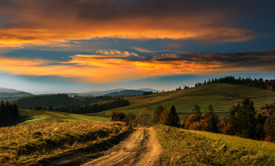 Wide road in the Carpathian Mountains at sunset.
