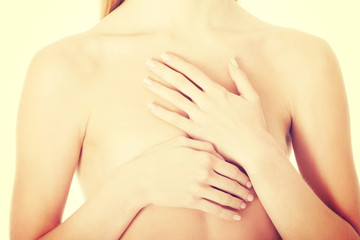 Fototapeta premium Beautiful caucasian naked woman covering her chest.