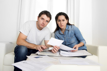young couple worried at home in stress accounting bank payments