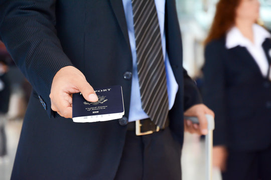 Businessman giving U.S. passport - check in & boarding concepts