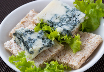 Sliced roquefort cheese on the  toasted bread