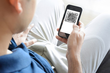 A man using smartphone while sitting