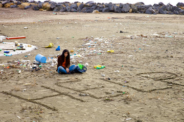 Woman desperate about dirt and pollution on the beach