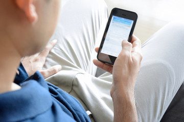 A man using smartphone while sitting