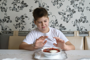 Teenager boy do not want to eat soup