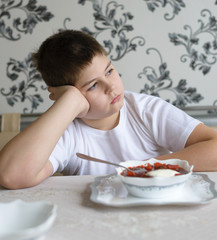 Teenager boy do not want to eat soup