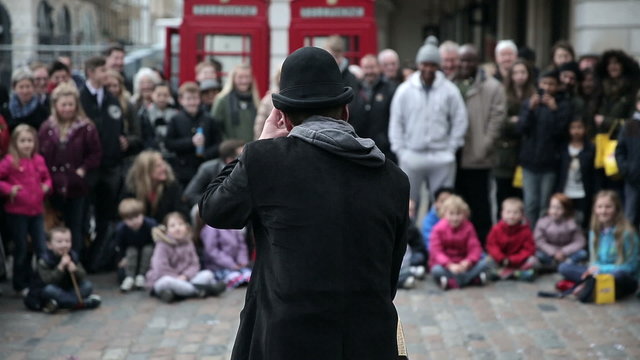 Street artist performing for crowd 