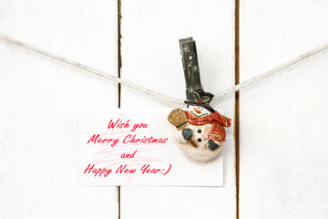 Christmas snowman clothespins holding greeting card