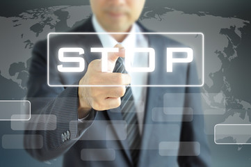 Businessman hand pointing to STOP sign on virtual screen