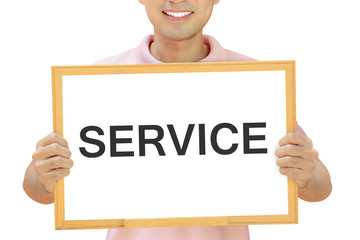 SERVICE sign on whiteboard held by smiling man