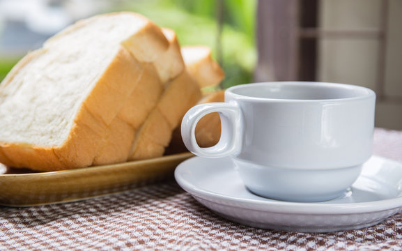 cup of coffee bread on table