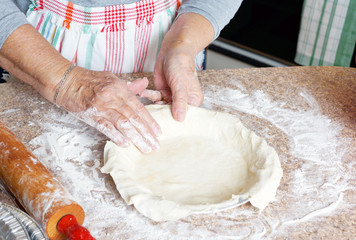Old hands making pie crust