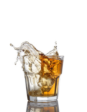 Isolated shots of whiskey with splash on white
