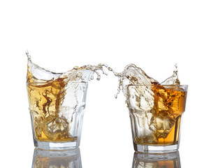 Isolated shots of whiskey with splash on white