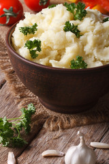 Tasty mashed potatoes with parsley in a bowl close-up vertical