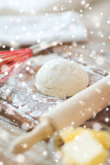 close up of dough and utensils on cutting board