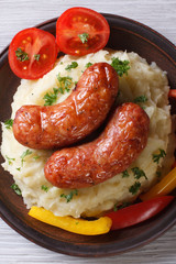 sausages with mashed potatoes closeup. top view vertical