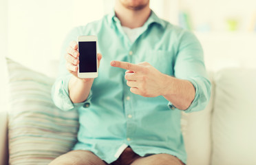 close up of man sitting with smartphone at home