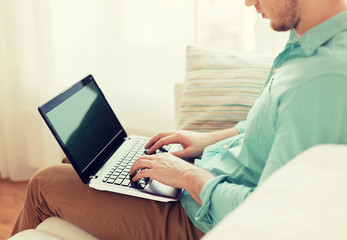 close up of man working with laptop at home