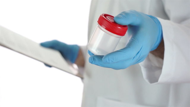 Doctor Turns With Urine Sample Cup