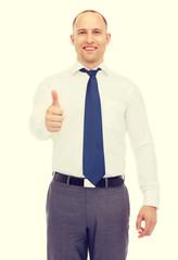 smiling businessman showing thumbs up