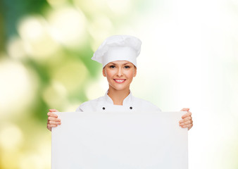 smiling female chef with white blank board