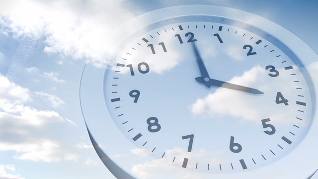 Clock ticking against blue sky