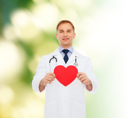 smiling male doctor with red heart and stethoscope