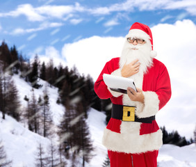 man in costume of santa claus with notepad