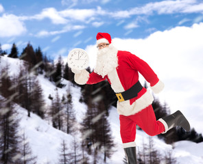 man in costume of santa claus with clock