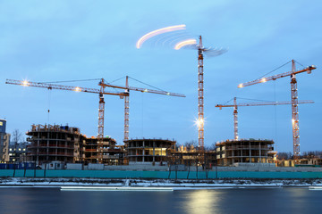Construction site of  residential building, tower cranes with ev