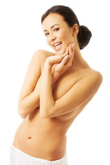 Fototapeta premium Portrait woman wrapped in towel touching chin