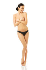 Obraz premium Nude woman standing, covering her breast