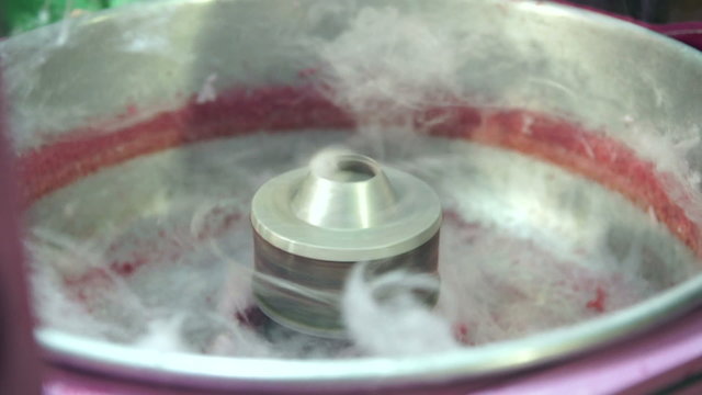 Candy floss or cotton candy being made at a fairground