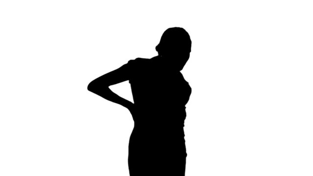 Woman getting back pain in black silhouette