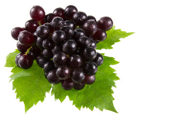 Sweet red grapes with leaf isolated on white.
