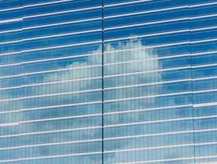 Cloud reflection on building window.