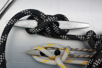 metal cleat with figure eight tied rope on boat or sail yacht	