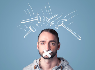 Young man with glued mouth and beating hammer marks