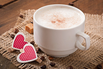 Cup of latte on the old wooden background