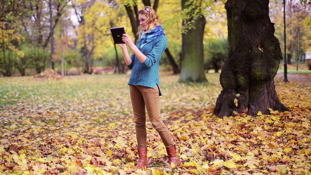 Girl taking photo of nature in the park