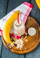 banana smoothie with oat flakes and milk in the bottle
