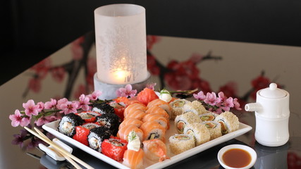 beautifully decorated table with sushi and sake