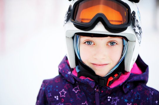 Young girl skier in winter resort
