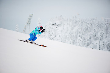 Young girl skier in winter resort