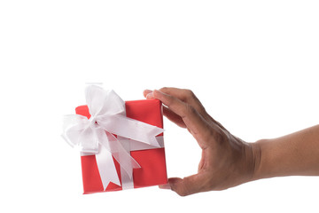 Hand holding red gift box on white background